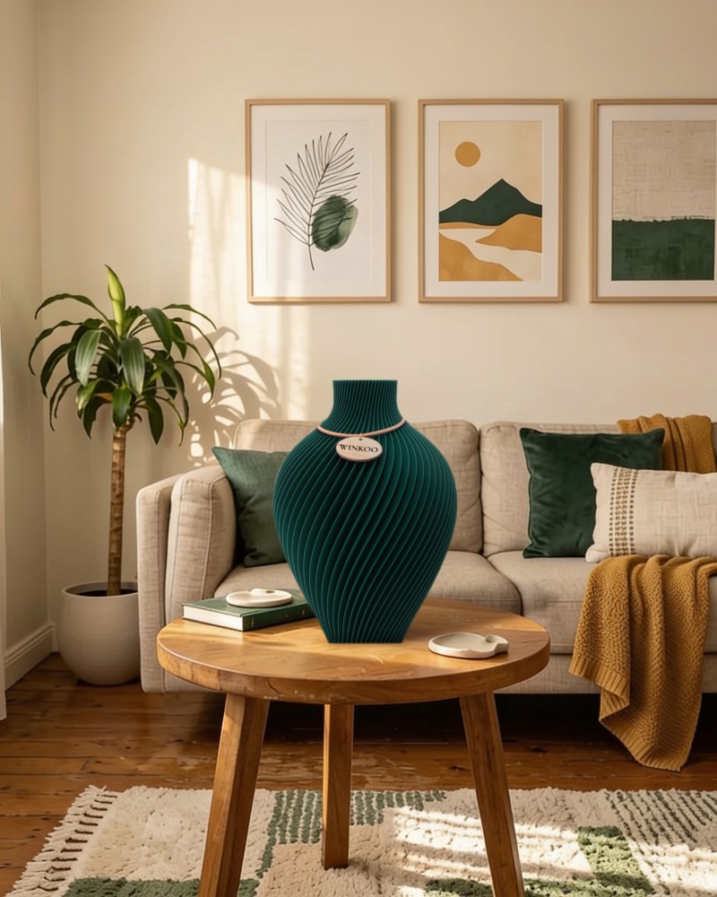 A Jade Green Noma vase in a warm living room, echoed by green cushions and art